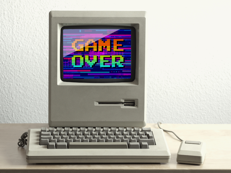 A vintage computer with Game Over displayed on the screen